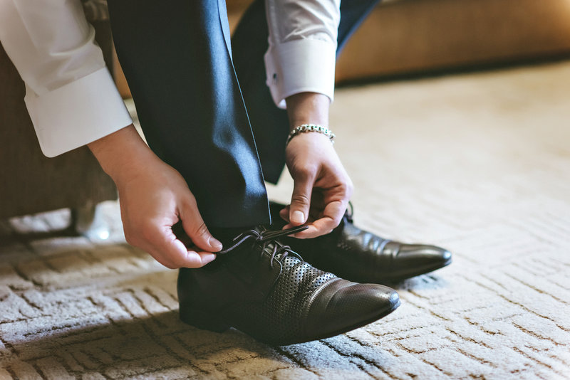 man putting shoes on before returning to work