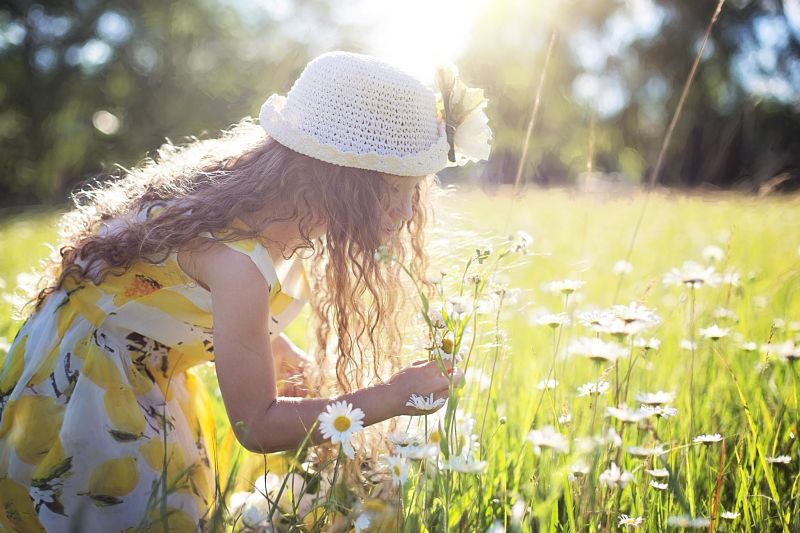 Young girl picking flowers