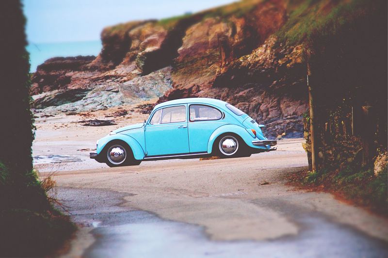 Blue Beetle parked on the beach