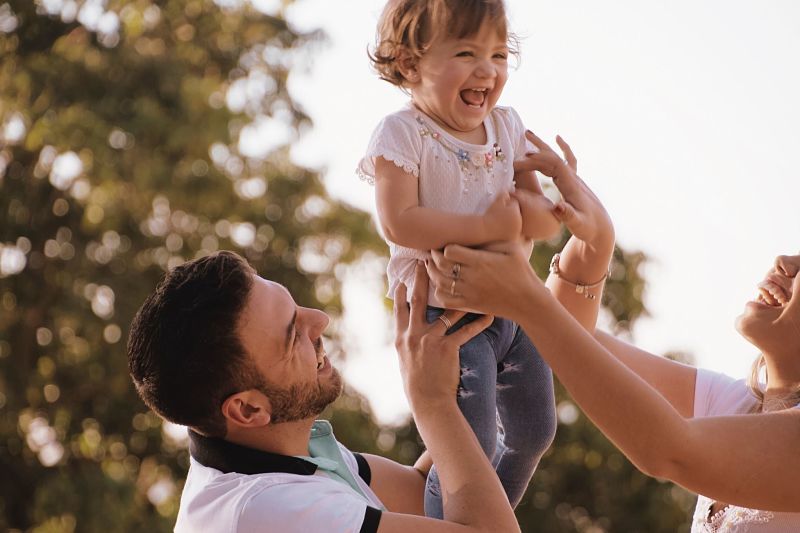 Parents holding toddler