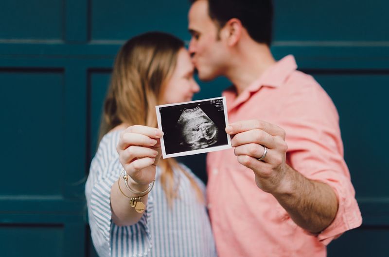 Couple holding pregnancy scan