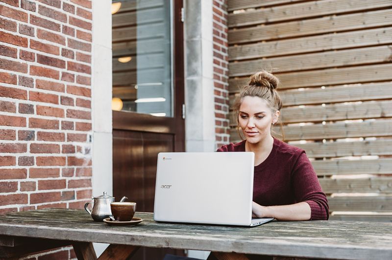 Girl working on laptop outside