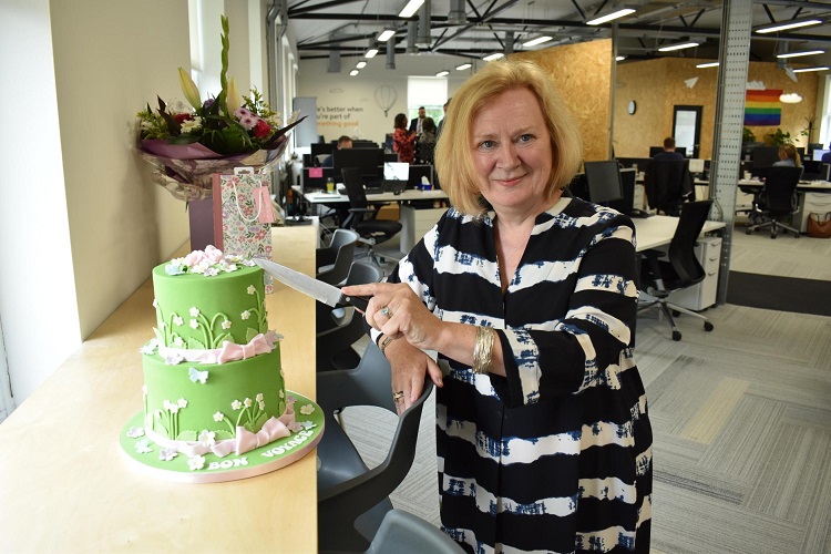 AGM News - Former Board member Joanne Hindle cuts into cake on her last day at Shepherds Friendly